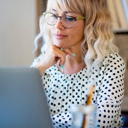 businesswoman-using-laptop-on-desk-confident-youn-2022-01-19-00-03-53-utc